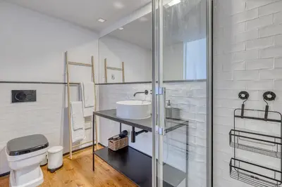 a bathroom with a sink and a toilet at Formosa Patio with Free Parking in Porto
