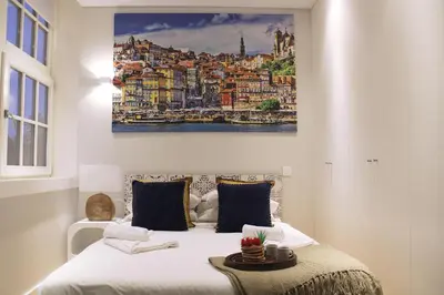 a bedroom with a bed with a painting on the wall at Artistic Neighborhood Luxury in Porto