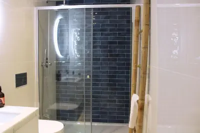 a bathroom with a shower with a glass door at Artistic Neighborhood Luxury in Porto