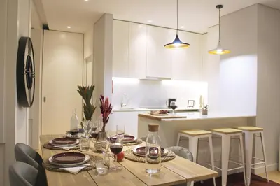 a kitchen and dining room with a table and chairs at Artistic Neighborhood Luxury in Porto