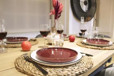 a table with red plates and glasses of wine at Artistic Neighborhood Luxury in Porto