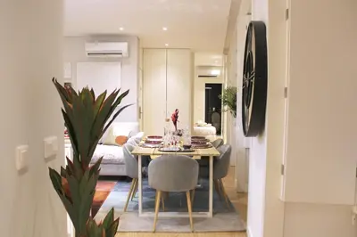 a dining room and living room with a table and chairs at Artistic Neighborhood Luxury in Porto