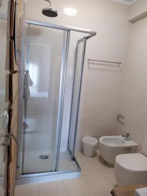 a bathroom with a shower and a toilet and a sink at Porto Grand Sasimi House in Porto