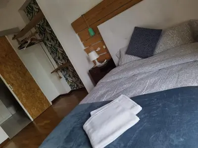 a bedroom with a large bed with a blue blanket at Porto Grand Sasimi House in Porto