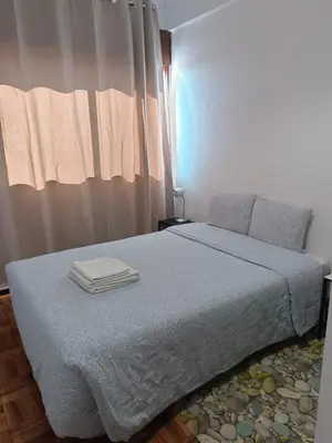 a bedroom with a bed with two towels on it at Porto Grand Sasimi House in Porto