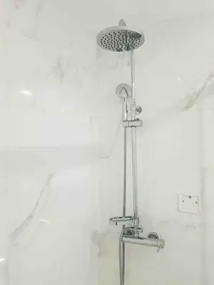 a shower in a bathroom with a white wall at Almada Downtown 102 in Porto