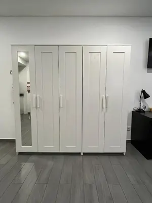 a room with white lockers and a wall at Almada Downtown 102 in Porto