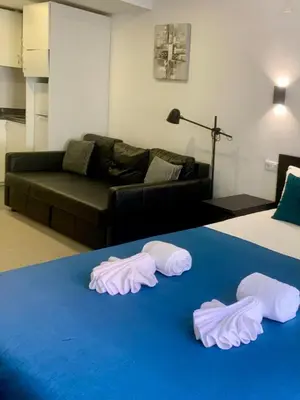 a room with a bed and two pairs of towels at Almada Downtown 103 in Porto