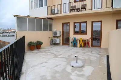 a patio with chairs and a table on a building at Casa do Pilar - D. Luís I in Vila Nova de Gaia