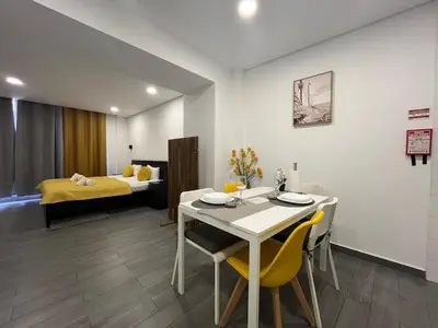 a room with a table and chairs and a bed at Almada Downtown 104 in Porto