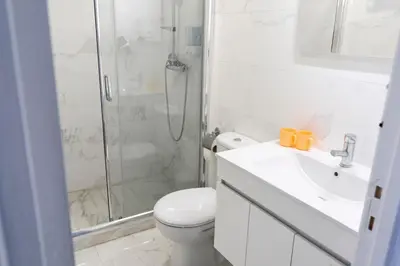 a bathroom with a shower and a toilet and a sink at Almada Downtown 104 in Porto