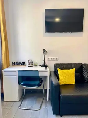 a living room with a desk and a couch at Almada Downtown 201 in Porto