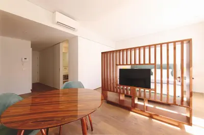a living room with a wooden table and a television at RIBEIRA FLORES 59 Downtown Apartments in Porto