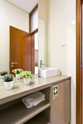 a bathroom with a sink and a mirror at Valentino Loft Porto Center - by Guest SPA in Porto