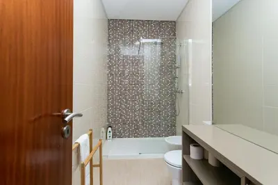a bathroom with a shower and a toilet and a sink at Valentino Loft Porto Center - by Guest SPA in Porto