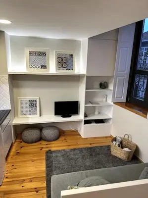 a living room with a tv and a couch at Almada One in Porto