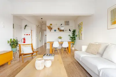 a living room with a white couch and a table at Serpa Downtown Gaia in Vila Nova de Gaia