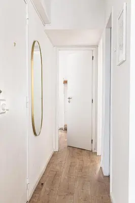 a hallway with a mirror and a white door at Serpa Downtown Gaia in Vila Nova de Gaia