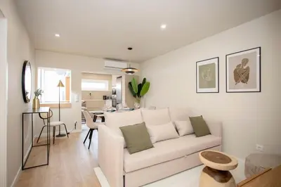 a white bedroom with a bed and a sliding door at Liiiving in Porto - Uptown Pearl Apartment in Porto