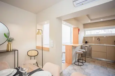 a white bedroom with a large bed with white sheets at Liiiving in Porto - Uptown Pearl Apartment in Porto