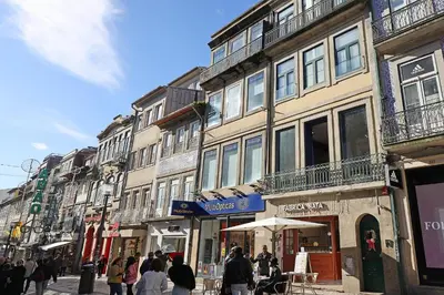 a group of people walking down a street with buildings at FLH Porto Downtown GuestHouse in Porto