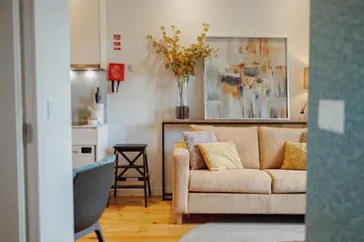 a living room with a couch and a kitchen at Oporto Pool Apartment by Vacationy in Porto