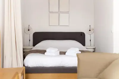 a bedroom with a bed with towels on it at VIVA Merchant's Way in Porto