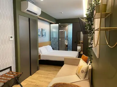 a hotel room with a bed and a couch at Oca Ribeira do Porto AT in Porto