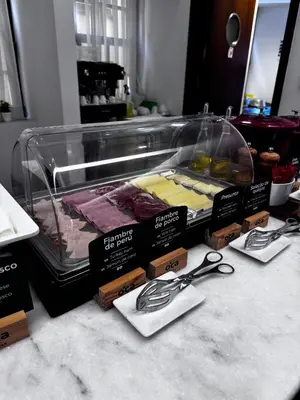 a display case with pairs of scissors on a counter at Oca Ribeira do Porto AT in Porto