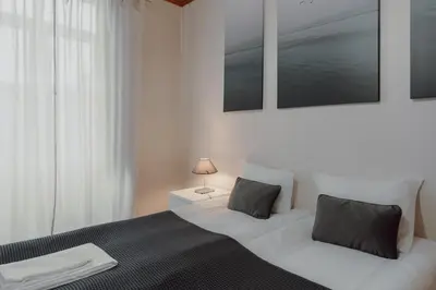 a bedroom with a large bed with two pillows at Alegria Four - Bedroom House in Porto