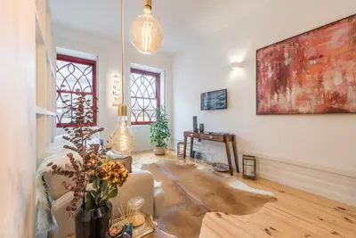 a living room with a couch and a painting on the wall at GuestReady - Rustic urban retreat in Porto