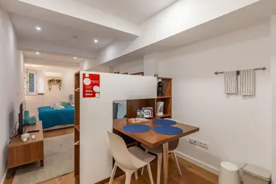 a small kitchen and dining room with a table and chairs at Underground Batalha Studios in Porto