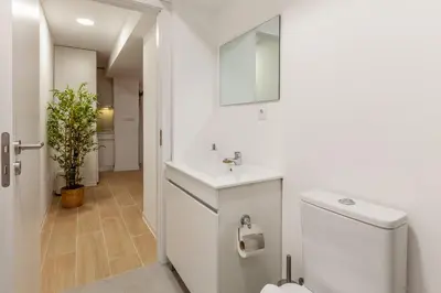 a white bathroom with a sink and a toilet at Underground Batalha Studios in Porto