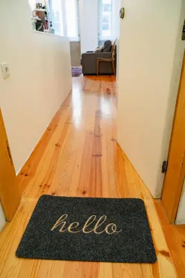 a welcome mat in the hallway of a house at Bolhão Studio, Porto in Porto
