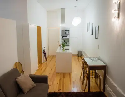 a living room with a couch and a table at Bolhão Studio, Porto in Porto