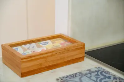a wooden box sitting on the floor next to a rug at Bolhão Studio, Porto in Porto