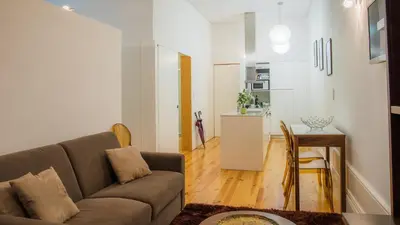 a living room with a couch and a table at Bolhão Studio, Porto in Porto