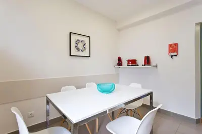 a white dining room with a white table and chairs at APOSENTUS - Serenity 1D in Porto