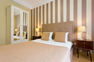 a bedroom with a large bed and a mirror at APOSENTUS - Serenity 2D in Porto