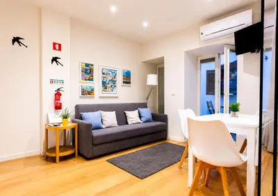 a living room with a couch and a table at Cozy apartment in the center of Porto in Porto