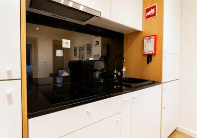 a kitchen with a counter with a sink and a mirror at Cozy apartment in the center of Porto in Porto