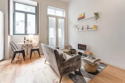 a living room with a chair and a table at Oporto Cozy Flats in Porto