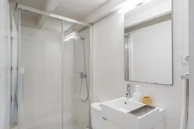 a white bathroom with a sink and a mirror at Oporto Cozy Flats in Porto