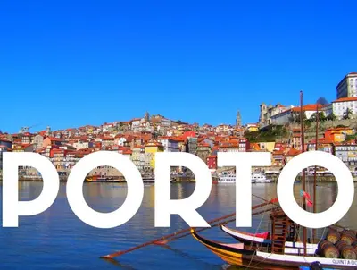 a group of boats in the water in front of a city at Oporto Cozy Flats in Porto