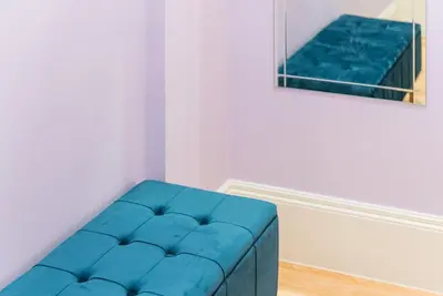 a blue couch in a white room with a painting at GuestReady - Seaside getaway in Porto in Porto