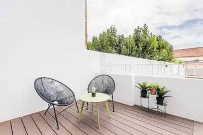 two chairs and a table on a balcony at GuestReady - Seaside getaway in Porto in Porto