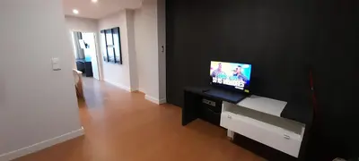 a living room with a television on a black wall at 504 New Apartment Galé in Porto