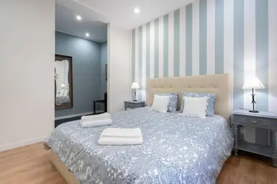 a bedroom with a bed with two pillows on it at APOSENTUS - Serenity Terrace in Porto