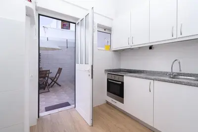 a white kitchen with a sink and a stove at APOSENTUS - Serenity Terrace in Porto
