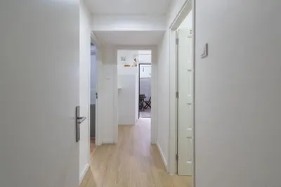 an empty hallway with white walls and wooden floors at APOSENTUS - Serenity Terrace in Porto